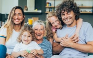 Family portrait displaying mom, dad, their two kids and the grand mother