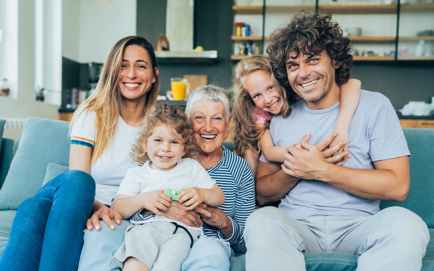 Family portrait displaying mom, dad, their two kids and the grand mother